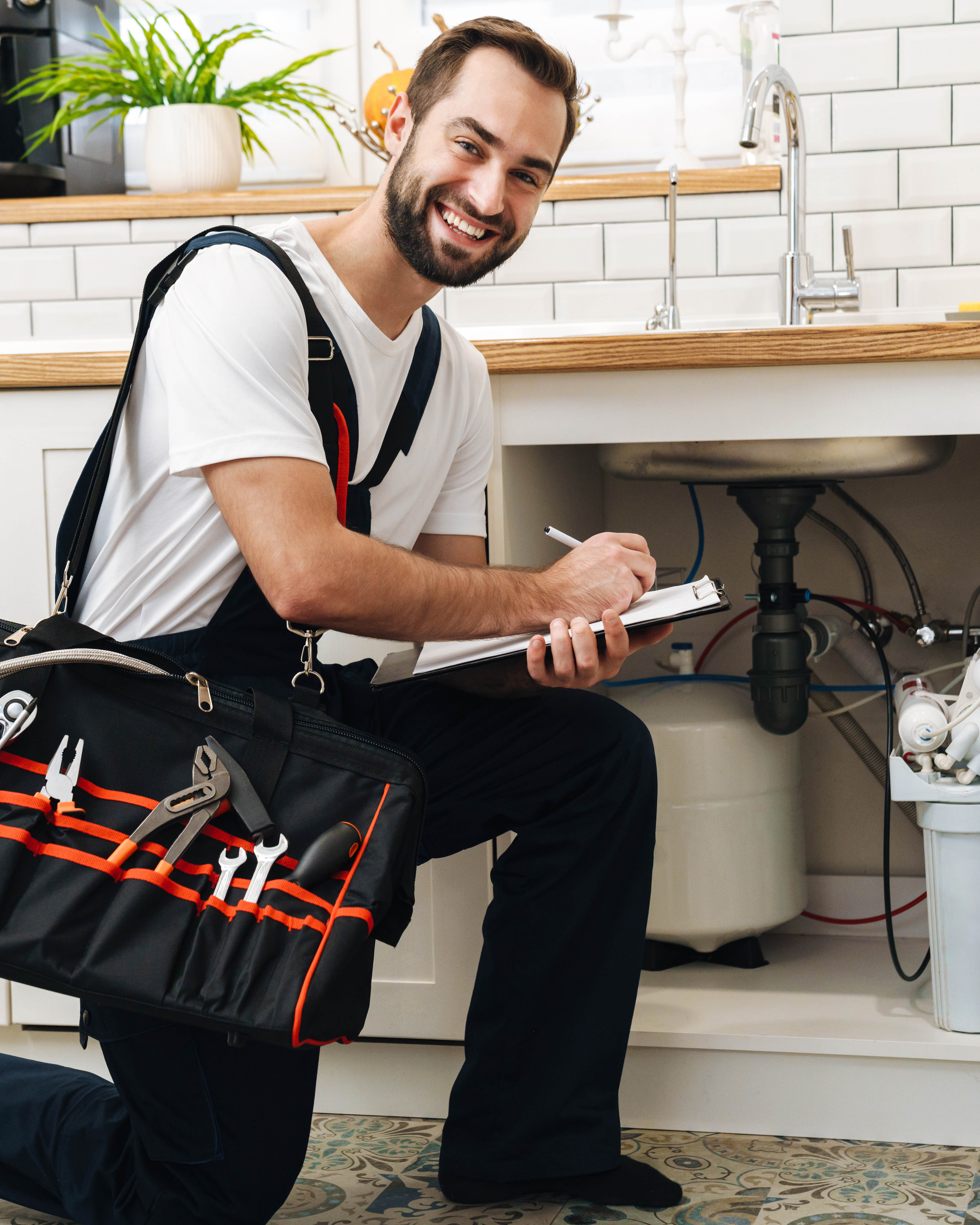 Licensed plumber in uniform holding a wrench, ready for a service call