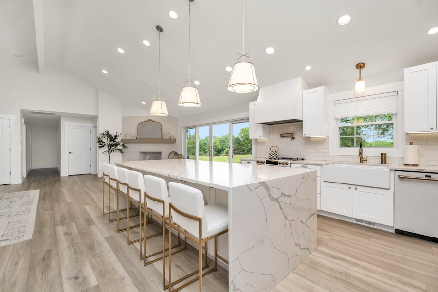 Beautifully renovated kitchen with marble island and white cabinetry